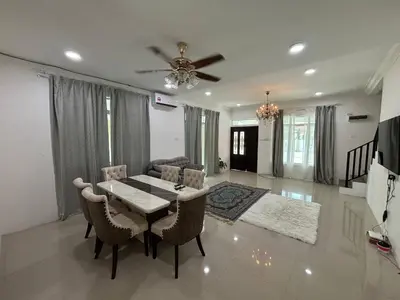 a living room with a table and chairs and a ceiling at Healing Homestay in Kampong Changkat Sedonan
