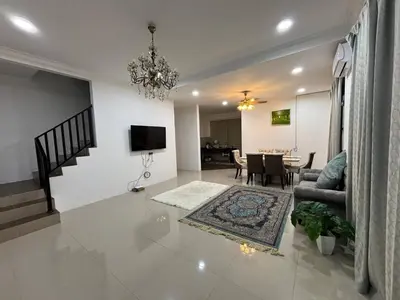a living room with a couch and a dining room at Healing Homestay in Kampong Changkat Sedonan