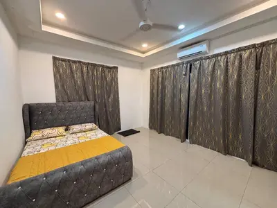 a bedroom with a bed and curtains in it at Healing Homestay in Kampong Changkat Sedonan