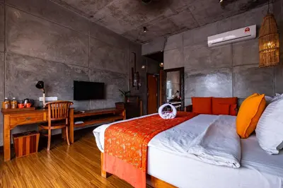 a bedroom with a bed and a desk and a television at Ipoh Bali Hotel in Ipoh
