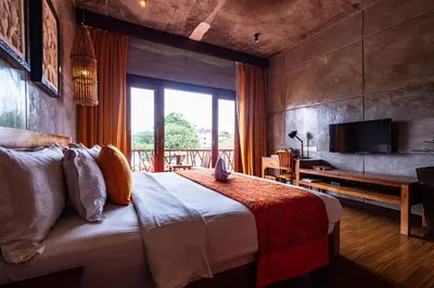 a bedroom with a large bed with a large window at Ipoh Bali Hotel in Ipoh
