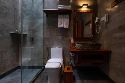 a bathroom with a toilet and a sink and a mirror at Ipoh Bali Hotel in Ipoh