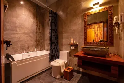 a bathroom with a tub and a sink and a bath tub at Ipoh Bali Hotel in Ipoh
