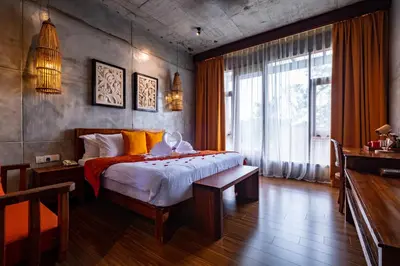 a bedroom with a large bed and a large window at Ipoh Bali Hotel in Ipoh