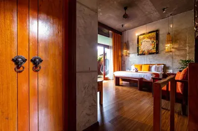 a room with a bedroom with a bed and a door at Ipoh Bali Hotel in Ipoh
