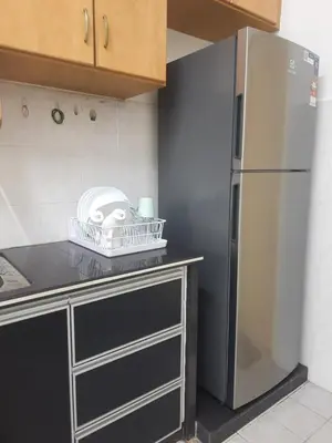 a kitchen with a stainless steel refrigerator at Cozy AiZHome in Balik Pulau