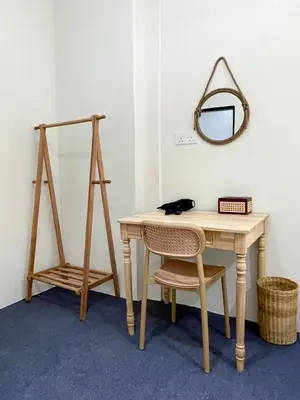 a table with a cat sitting on a chair next to a mirror at Bali Nordic American Guest House Style By Nest at Beach St George Town Penang in George Town