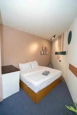 a bedroom with a large bed with a white bedspread at Bali Nordic American Guest House Style By Nest at Beach St George Town Penang in George Town