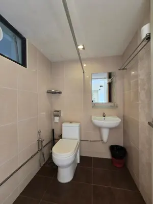 a bathroom with a toilet and a sink at Sunshine Seaview Apartment in Batu Ferringhi