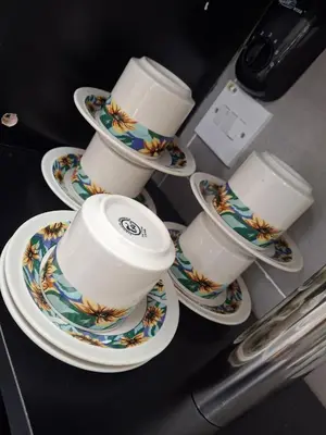 a group of cups and saucers on a counter at 1132 D' KHASIEH Homestay in Kampong Sungai Wangi Dalam