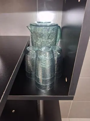 a group of glass cups sitting on a shelf at 1132 D' KHASIEH Homestay in Kampong Sungai Wangi Dalam