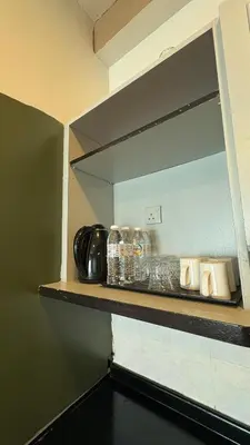 a shelf in a kitchen with some dishes on it at Sky beach resort in Tanjung Bungah