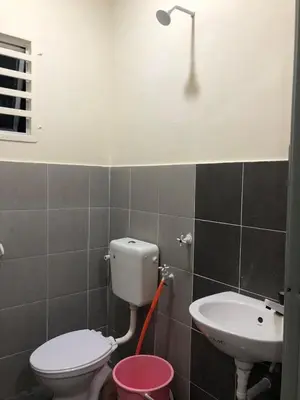 a bathroom with a toilet and a sink at Teratak Arissa Homestay in Sitiawan
