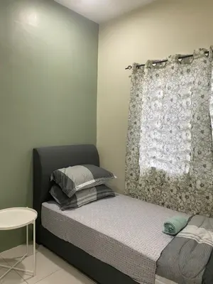 a small bedroom with a bed and a window at Teratak Arissa Homestay in Sitiawan