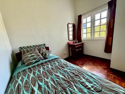 a bedroom with a bed and a window at A Highland Retreat in Tanah Rata in Tanah Rata