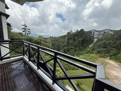 a balcony with a view of a forest at A Highland Retreat in Tanah Rata in Tanah Rata