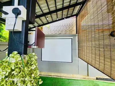 a garage door with a white sign on it at Cozy Villa - Private Pool, 5BR, KTV, BBQ, PS5 just 3 Mins to Batu Ferringhi Beach! in Batu Ferringhi