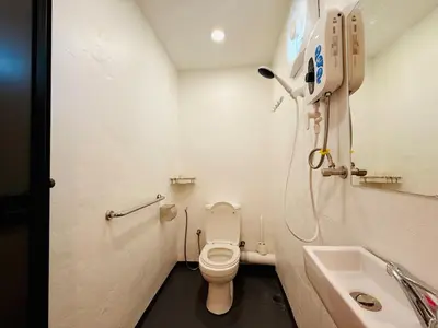 a small bathroom with a toilet and a sink at WhiteZen Family Homestay 9Room for 20pax Central Penang in Jelutong