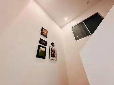 a room with pictures on the wall and a tv at WhiteZen Family Homestay 9Room for 20pax Central Penang in Jelutong