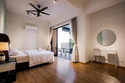 a bedroom with a bed and a mirror and a balcony at The Cove Hillside Residence Ipoh by PLY Home in Ipoh