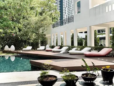 a row of white chairs sitting next to a pool at The Cove Hillside Residence Ipoh by PLY Home in Ipoh