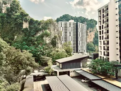 a view of a building with mountains in the background at The Cove Hillside Residence Ipoh by PLY Home in Ipoh