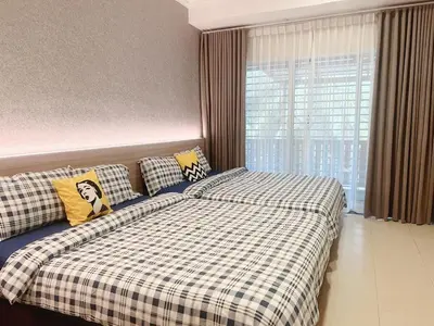 a bedroom with a bed with a checkered blanket at Sitiawan 2-storey 4room5BedsWifi 10pax near Jetty in Sitiawan