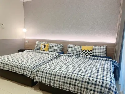 two beds sitting next to each other in a bedroom at Sitiawan 2-storey 4room5BedsWifi 10pax near Jetty in Sitiawan