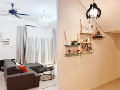 a living room with a couch and a ceiling fan at Sitiawan 2-storey 4room5BedsWifi 10pax near Jetty in Sitiawan