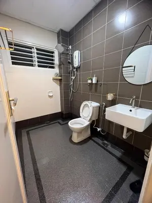 a bathroom with a toilet and a sink and a mirror at Sitiawan 2-storey 4room5BedsWifi 10pax near Jetty in Sitiawan