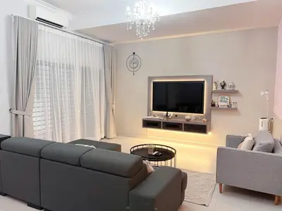 a living room with a couch and a tv at Sitiawan 2-storey 4room5BedsWifi 10pax near Jetty in Sitiawan