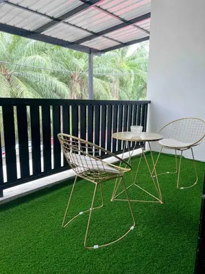 two chairs and a table on a balcony at Sitiawan 2-storey 4room5BedsWifi 10pax near Jetty in Sitiawan