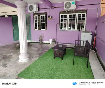 a purple house with two chairs and a pillar at Ed 02 manjung in Seri Manjung
