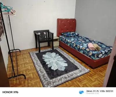 a bedroom with a bed and a table and a rug at Ed 02 manjung in Seri Manjung
