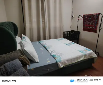 a bed with a quilt on it in a room at Ed 02 manjung in Seri Manjung