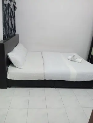 a bed in a room with a white floor at Dynamic smartstay in Ipoh