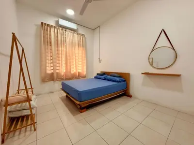 a bedroom with a blue bed and a mirror at 28 Harmoni Homestay, Kamunting in Kamunting