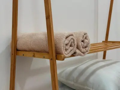 a wooden bunk bed with towels on it at 28 Harmoni Homestay, Kamunting in Kamunting