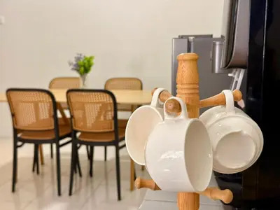 a group of cups sitting on top of a tv at 28 Harmoni Homestay, Kamunting in Kamunting