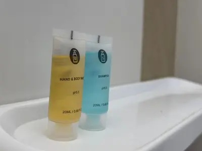 two bottles of moisturizers sitting on top of a sink at 28 Harmoni Homestay, Kamunting in Kamunting