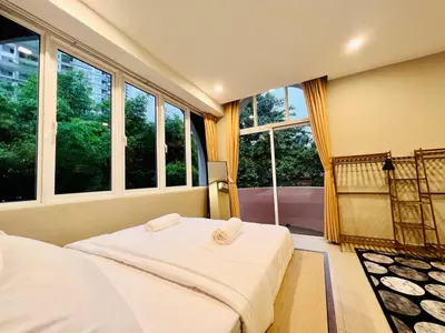 a bedroom with two beds and large windows at Family Fun Private Pool Villa with KTV, BBQ, PS5, POOL TABLE, KITCHEN just 2-Minute Drive to Tanjung Bungah Beach in Tanjung Bungah