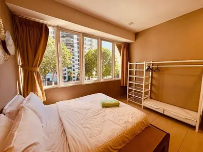 a bedroom with a bed and a window at Family Fun Private Pool Villa with KTV, BBQ, PS5, POOL TABLE, KITCHEN just 2-Minute Drive to Tanjung Bungah Beach in Tanjung Bungah