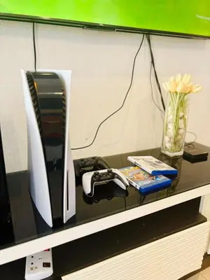 a desk with a computer monitor and a vase of flowers at Family Fun Private Pool Villa with KTV, BBQ, PS5, POOL TABLE, KITCHEN just 2-Minute Drive to Tanjung Bungah Beach in Tanjung Bungah