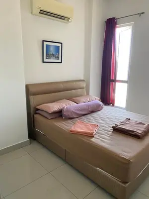 a bed in a room with two pillows on it at 1 room at my apartment at Chez Marcel in Tanjung Bungah