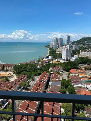 a view of a city and the ocean from a balcony at 1 room at my apartment at Chez Marcel in Tanjung Bungah