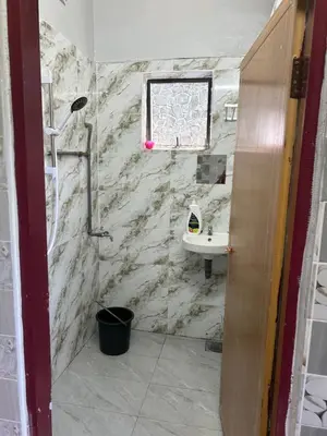 a bathroom with a shower and a sink at Chengai Homestay in Sungkai