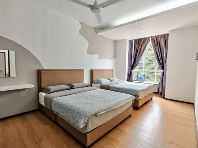 a bedroom with two beds and a window at DawnBlue Cameron Highlands in Brinchang