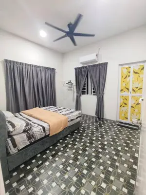 a bedroom with a bed and a ceiling fan at Rumah Pak Syed in Ipoh