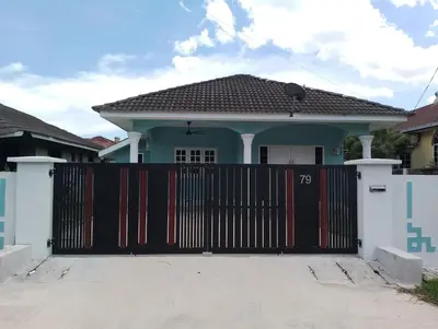 a house with a gate in front of it at Rumah Pak Syed in Ipoh