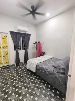 a bedroom with a bed and a ceiling fan at Rumah Pak Syed in Ipoh